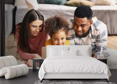 Multiracial family looking at laptop during quarantine Wall mural