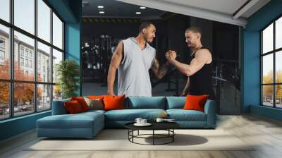 Muscular men shaking hands at gym Wall mural