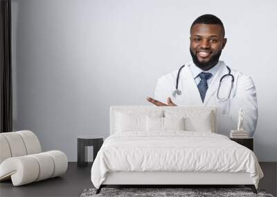 Note it, space for advertisement. Friendly black doc with arms crossed pointing at empty space over white background, panorama Wall mural