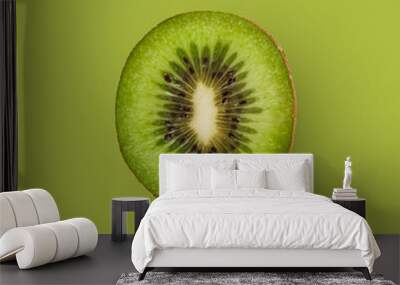 One fresh ripe kiwi fruit isolated on green background, square Wall mural