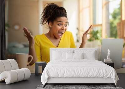 Overjoyed african american lady looking at laptop and screaming WOW, being happy over huge sale in web store Wall mural