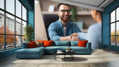 Partnership. Smiling Male Entrepreneur Giving Hand For Handshake To Female In Office Wall mural