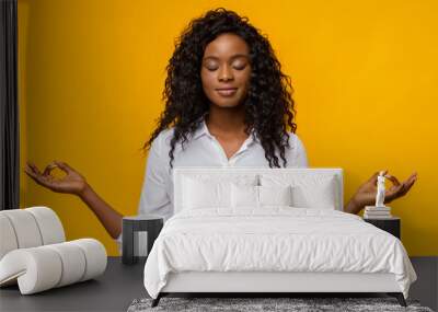 Peaceful afro girl with closed eyes practicing breathing yoga Wall mural