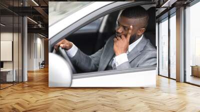 Pensive african businessman leaning on his hand while driving car Wall mural