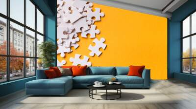 Pile of puzzles ob yellow background, copy space Wall mural