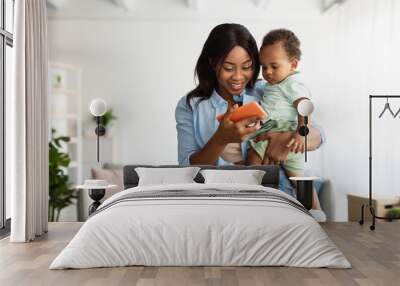 Portrait of african american family using cellphone at home Wall mural