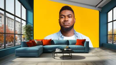 Portrait of african american man with sceptical face expression Wall mural