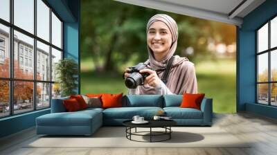 Portrait of beautiful muslim woman photographer with digital camera Wall mural