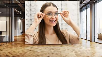 Portrait of beautiful young woman wearing spectacles Wall mural