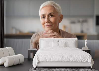 Portrait of confident european senior lady with stylish haircut indoor Wall mural