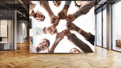 Portrait of diverse business people giving fist bump in cirle Wall mural