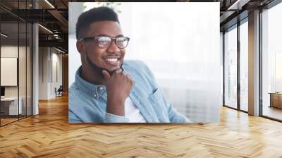 Portrait of handsome smiling african american man in glasses Wall mural