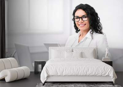 Portrait of happy latin girl using tablet and computer Wall mural