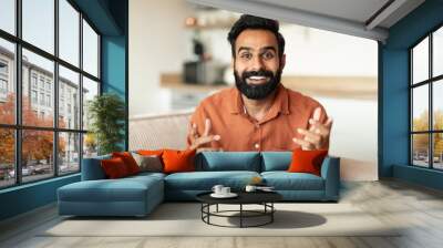 Portrait of indian man talking looking at camera at home Wall mural