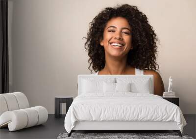 portrait of laughing young woman against light background Wall mural