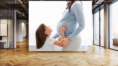 Portrait of pregnant young woman and her little girl Wall mural