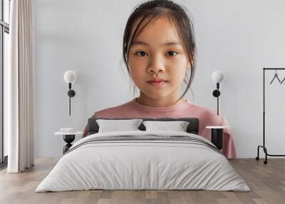 portrait of serious asian girl looking at camera, gray background Wall mural