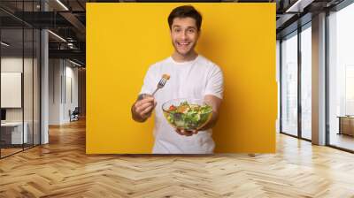 Portrait of Smiling Guy Holding Bowl With Salad Wall mural