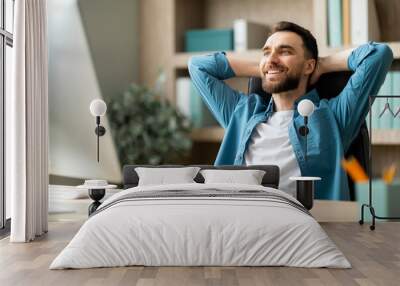 Portrait Of Smiling Millennial Male Entrepreneur Relaxing At Workplace In Office Wall mural