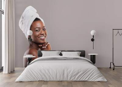 Positive african american woman enjoying spa procedures Wall mural