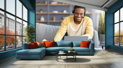 Positive black guy attending online training from home Wall mural