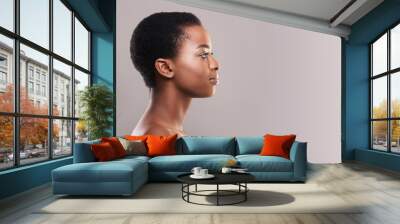 Profile portrait of afro woman with clean flawless skin Wall mural