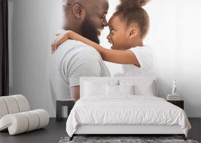 Profile portrait of black father and daughter bonding over white Wall mural