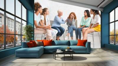 Psychologist Comforting Girl During Therapy Session With Support Group Indoors Wall mural