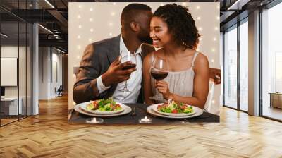 Romantic black couple having dinner at restaurant Wall mural