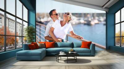 Romantic Senior Couple Embracing Expressing Happiness Standing At Marina Outside Wall mural