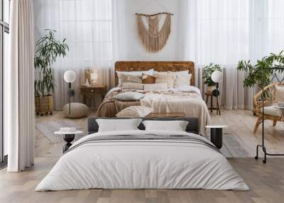 Rustic home design with ethnic boho decoration. Bed with pillows, wooden furniture Wall mural