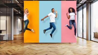 Satisfied happy excited international young people jumping, have fun and flying in air Wall mural