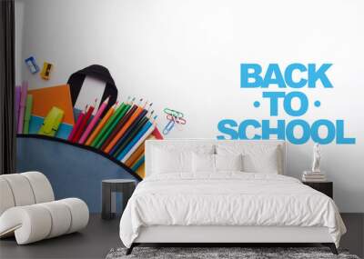 School backpack with colored stationery on white background Wall mural