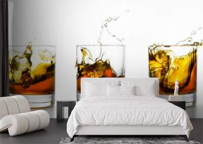 Scotch glasses with whiskey splashing from them Wall mural