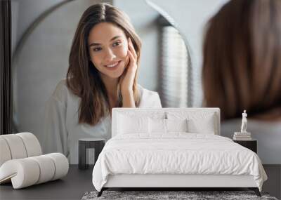 Self-Care Concept. Young Attractive Woman Looking At Mirror In Bathroom Wall mural