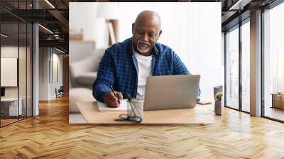 Senior Black Man At Laptop Taking Notes Indoors Wall mural