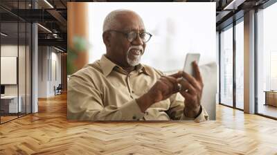 Senior Black Man Texting On Smartphone Using Application At Home Wall mural