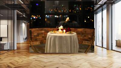 Served Table With Food And Burning Candles In Restaurant Interior Wall mural