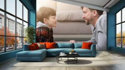 Side view of handsome father and son looking at each other Wall mural