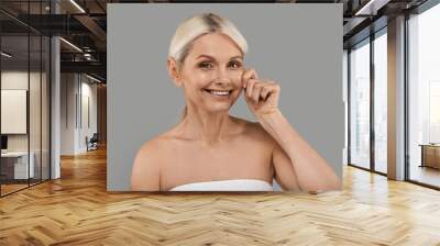 Skin Firming Concept. Beautiful Senior Woman Touching Her Face And Smiling Wall mural