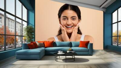 Skincare Concept. Beautiful young indian woman touching face and looking at camera Wall mural