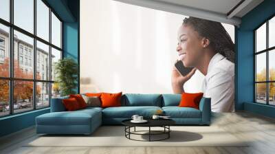 Smiling African American Businesswoman Talking On Cellphone In Office Wall mural