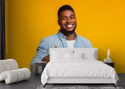 Smiling african american man showing thumb up at camera Wall mural