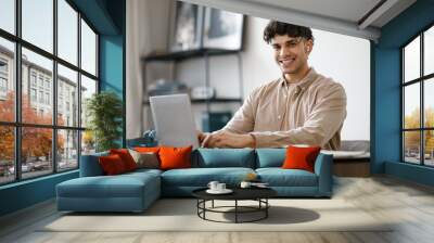 Smiling Arab Man Entrepreneur Working With Laptop At Home Interior Wall mural