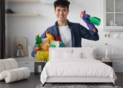 Smiling asian man house-keeper cleaning apartment, copy space Wall mural