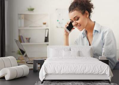 smiling business woman at work talking on phone Wall mural