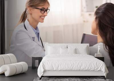 Smiling Doctor Comforting Patient During Medical Appointment In Her Office Wall mural