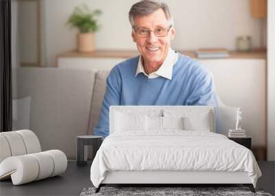 Smiling Senior Gentleman Sitting On Couch At Home Wall mural