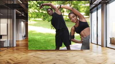 Sporty African Couple Doing Fitness Workout Together In Summer Park, Stretching Muscles Wall mural