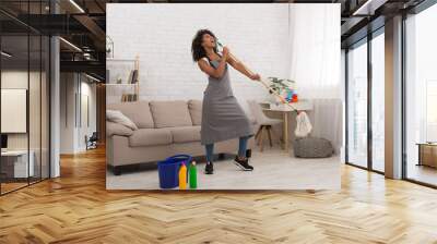 Spring cleaning woman singing fun using mop Wall mural